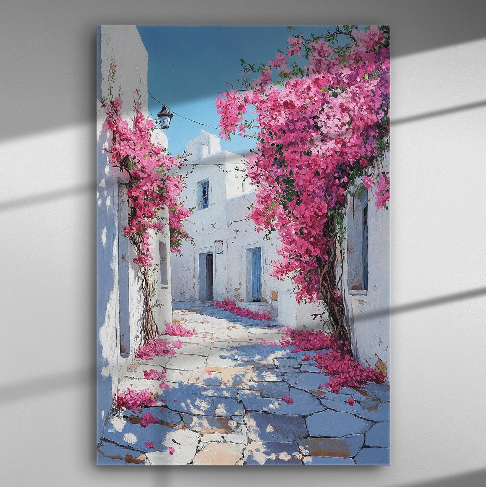 Canvas print depicting a picturesque alley with pink bougainvillea flowers and white-washed buildings.