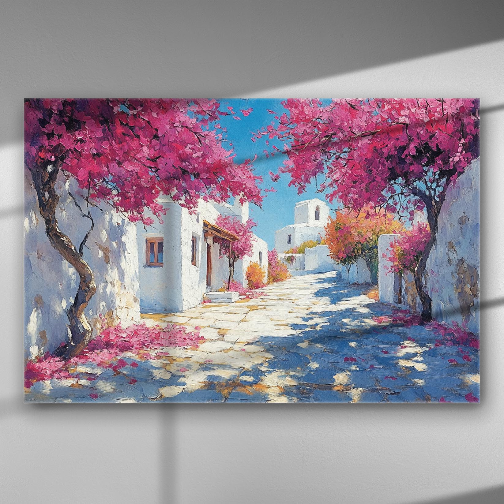 Canvas print showing a Greek island street with white houses and blooming pink bougainvillea.