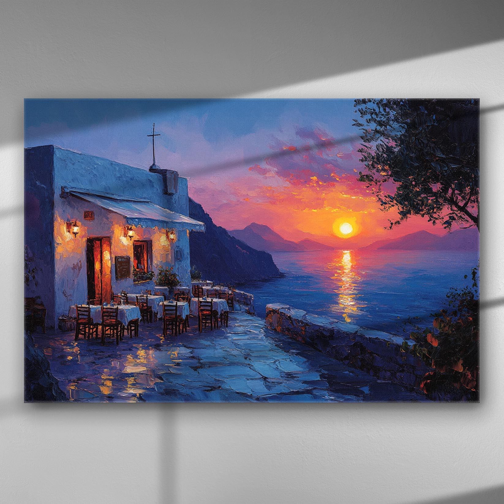 Canvas print of a sunset with a sea view, featuring a Greek terrace café with tables.
