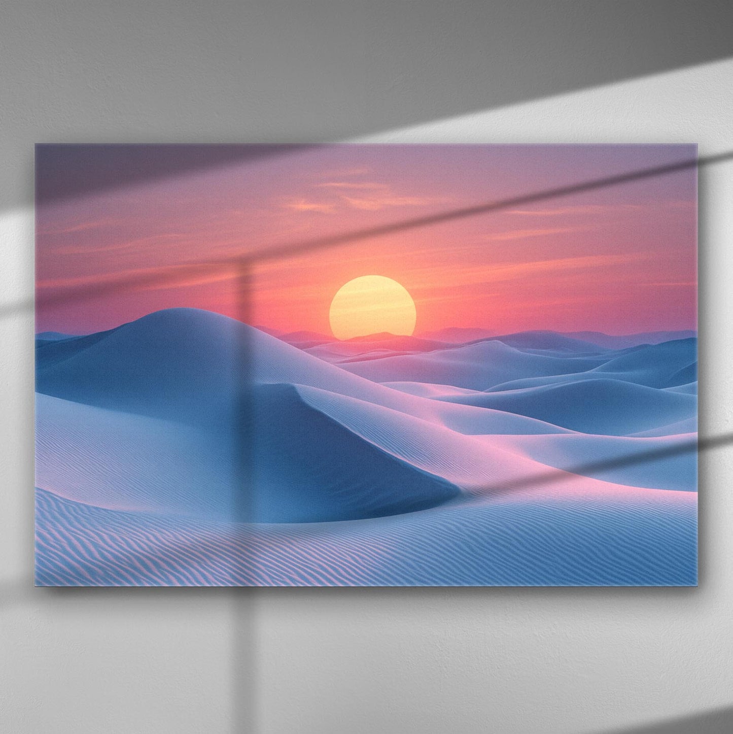 Desert landscape at sunset with soft blue dunes and a vibrant pink and orange sky