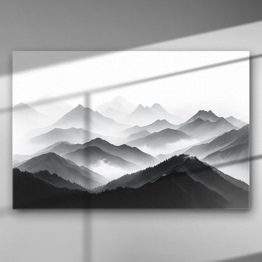 A black and white foggy mountain range with layers of hills and misty atmosphere.
