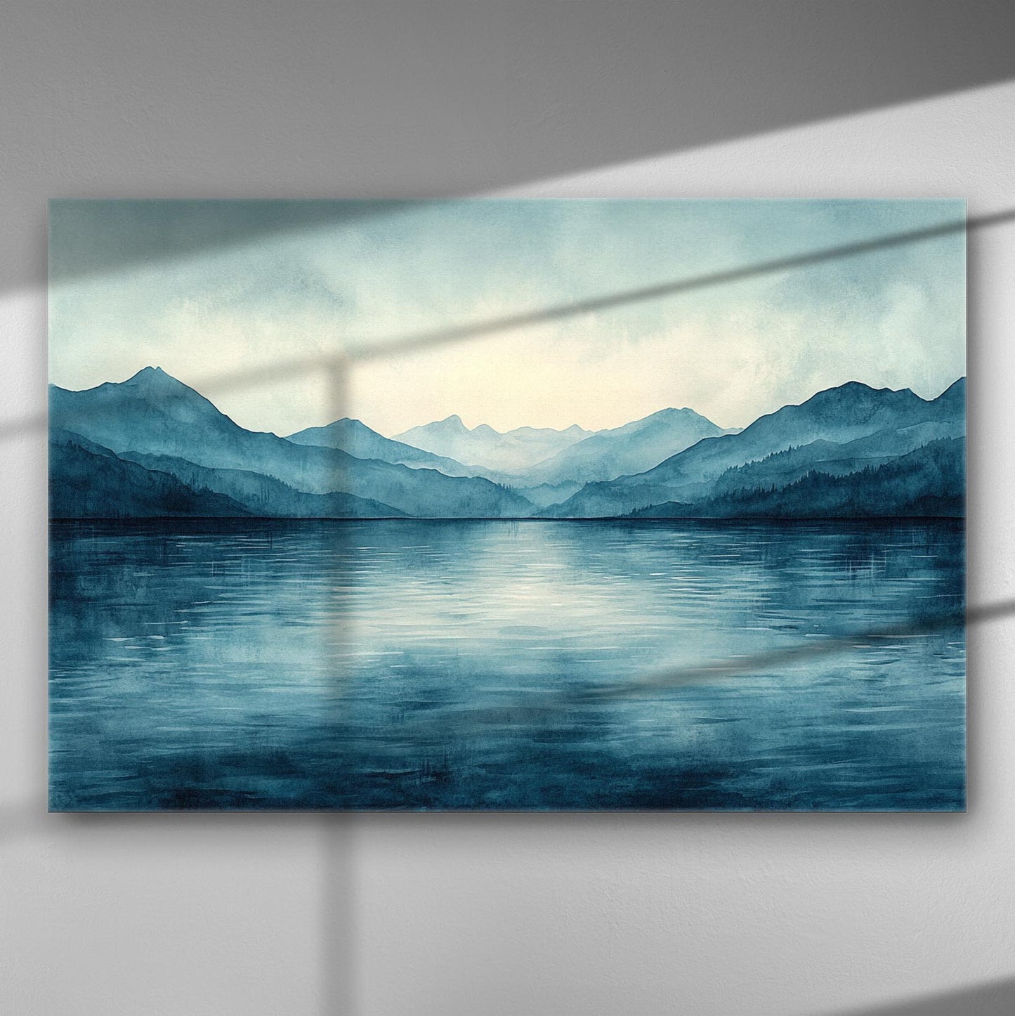 Serene mountain range with blue hues reflecting on calm water.