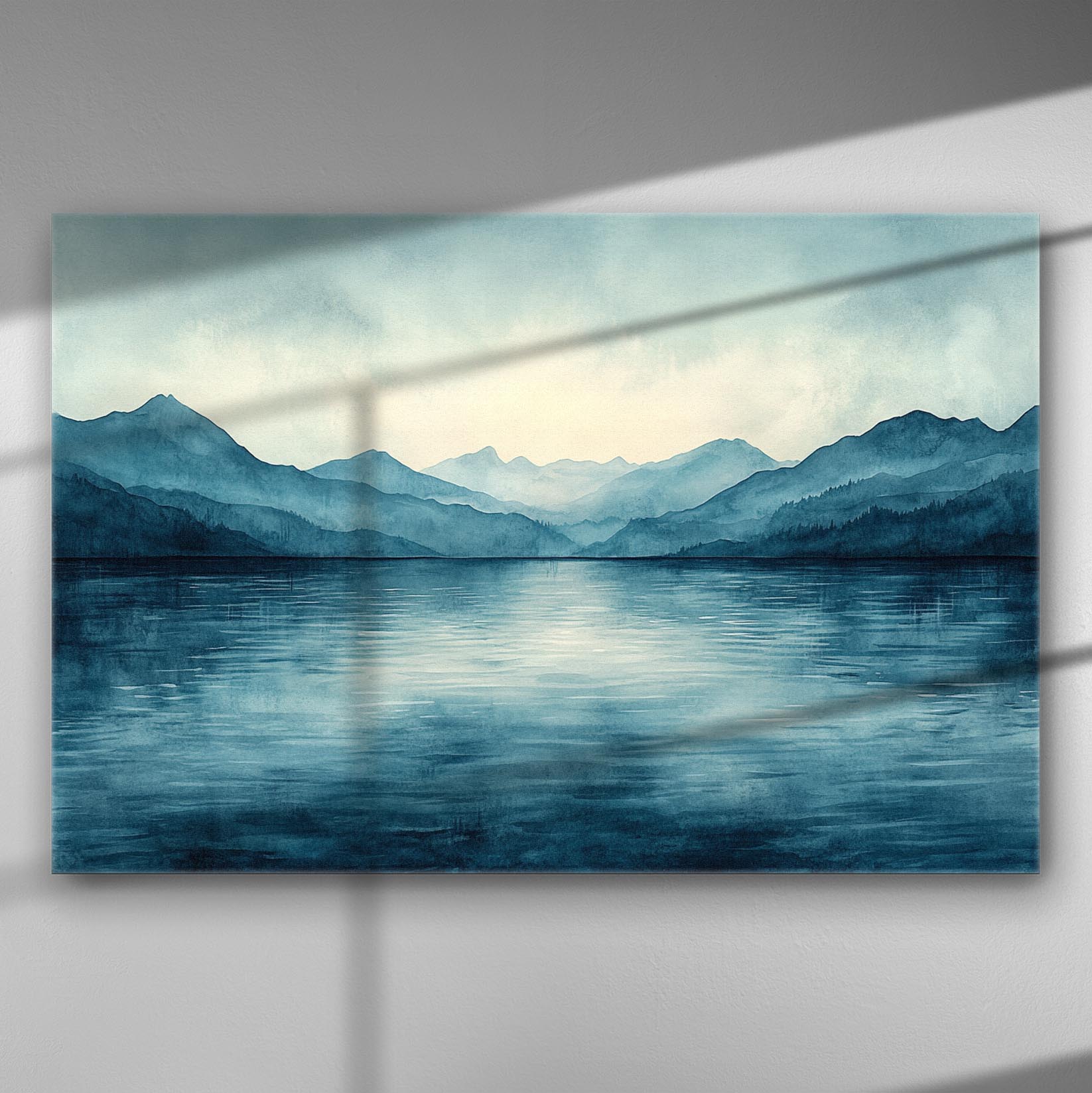 Serene mountain range with blue hues reflecting on calm water.
