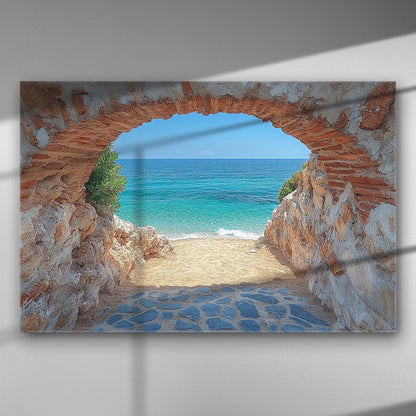 Canvas print depicting a beach view through a stone archway with blue sea and sandy shore.