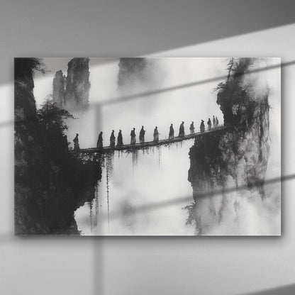 Monochrome scene of figures walking over a narrow bridge between misty mountains.