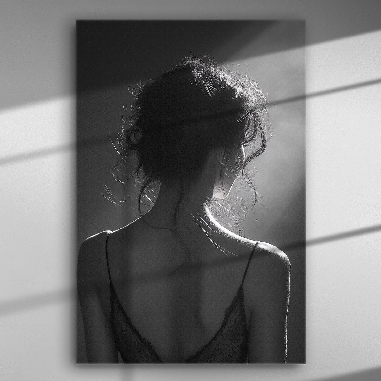 Black and white image of a woman's silhouette with back light and shadows.