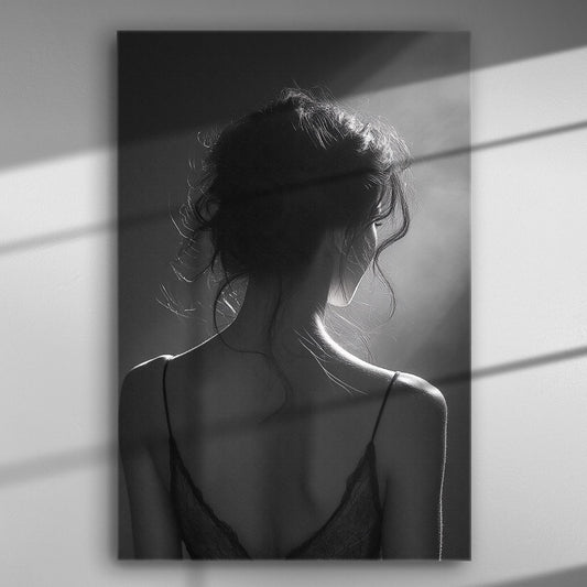 Black and white image of a woman's silhouette with back light and shadows.