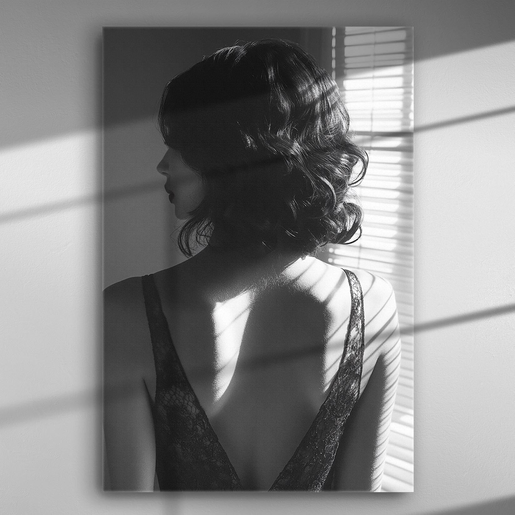 Black and white silhouette of a woman with light from blinds highlighting her back.