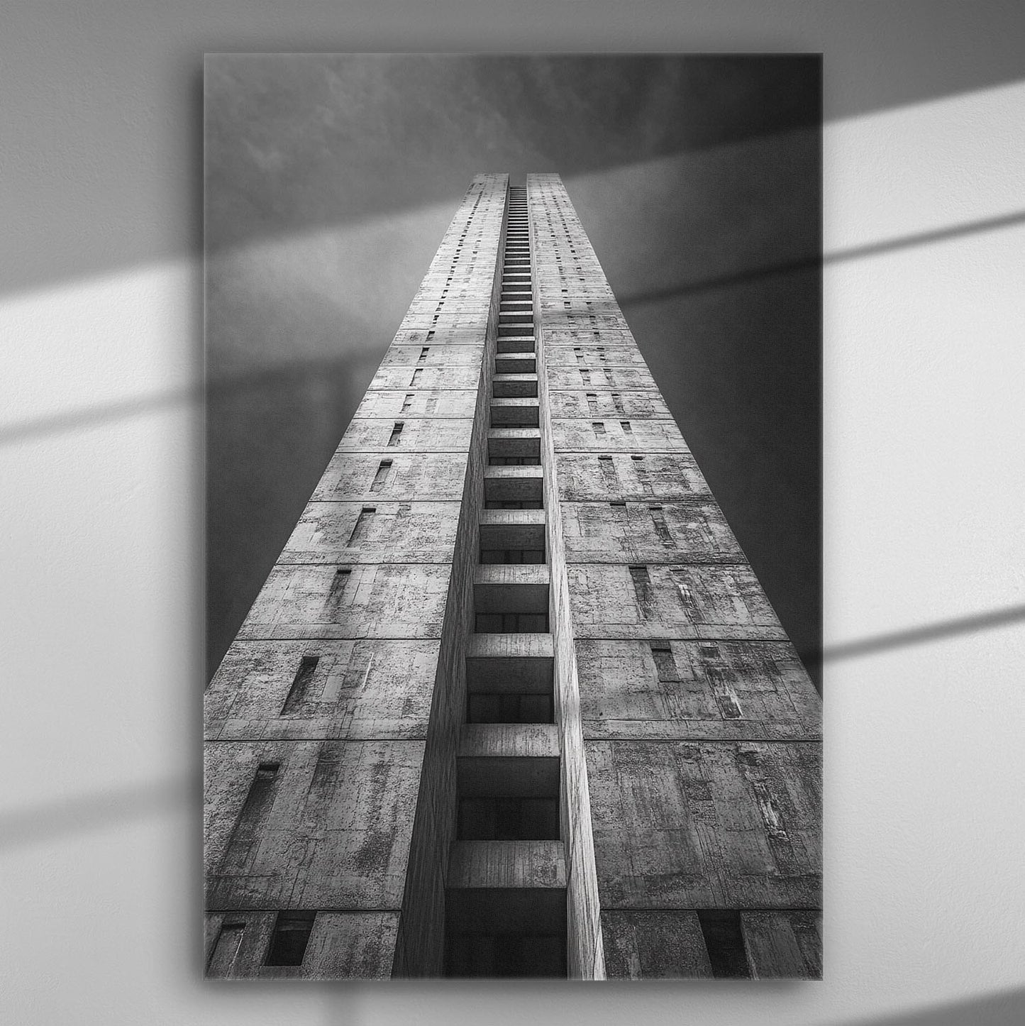 Black and white image of a tall, modern architectural tower reaching into the sky.