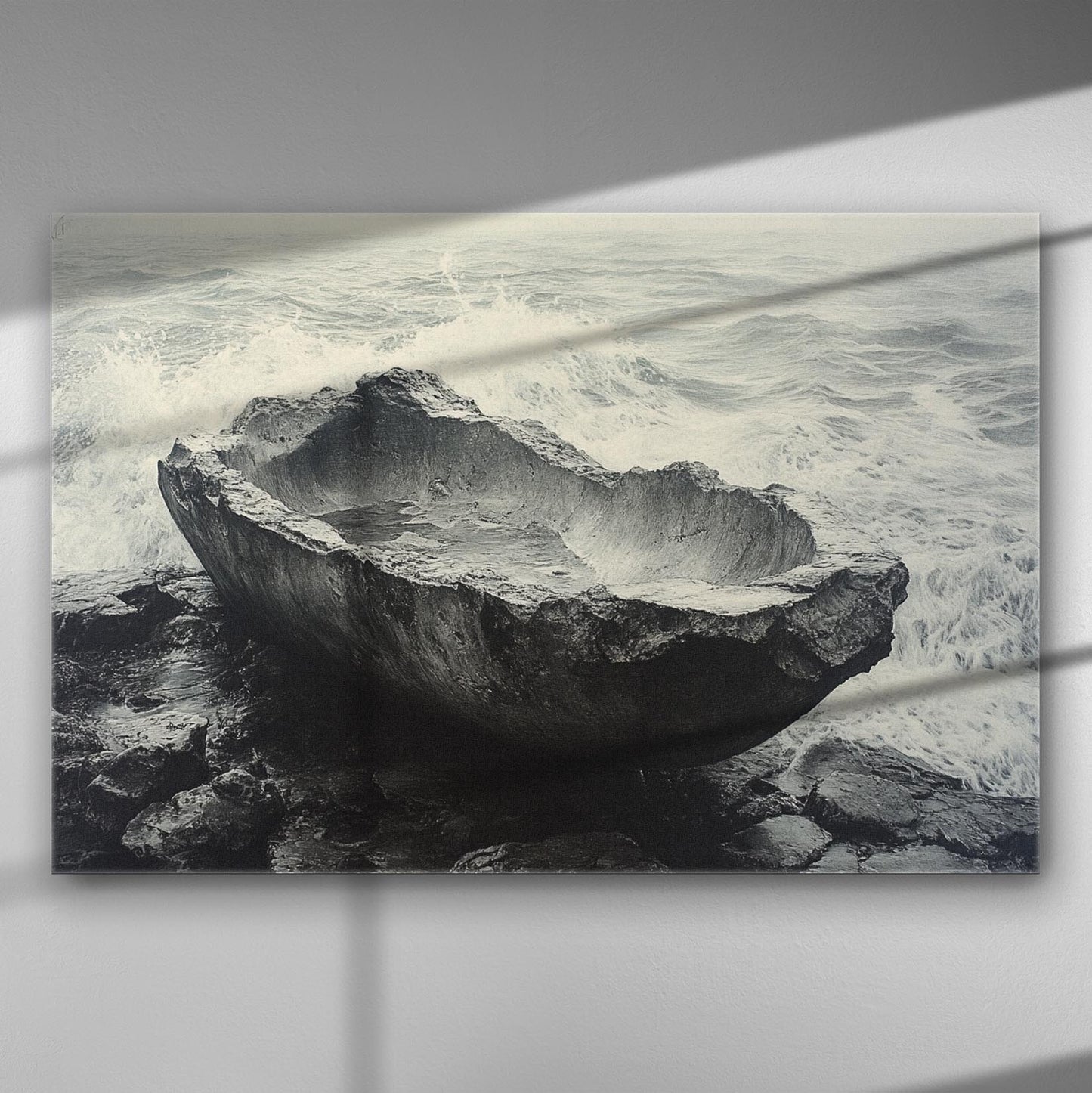 Black and white canvas print featuring a stone vessel by the sea with waves in the background.