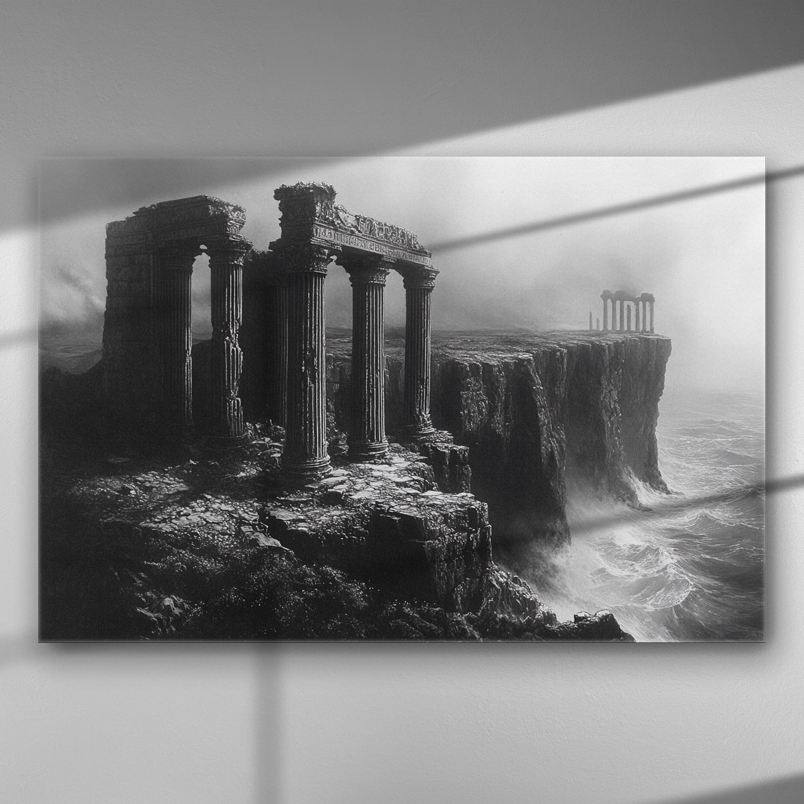 Black and white image of ancient ruins shrouded in mist on a cliff.