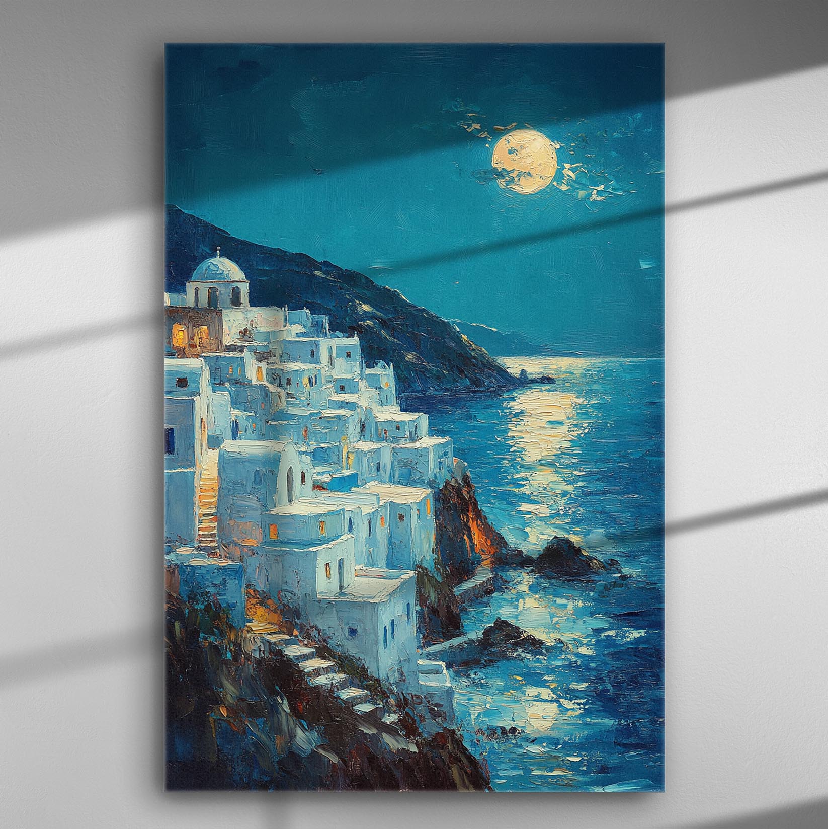 Night scene of Aegean Sea with a full moon shining over white houses on a cliff.