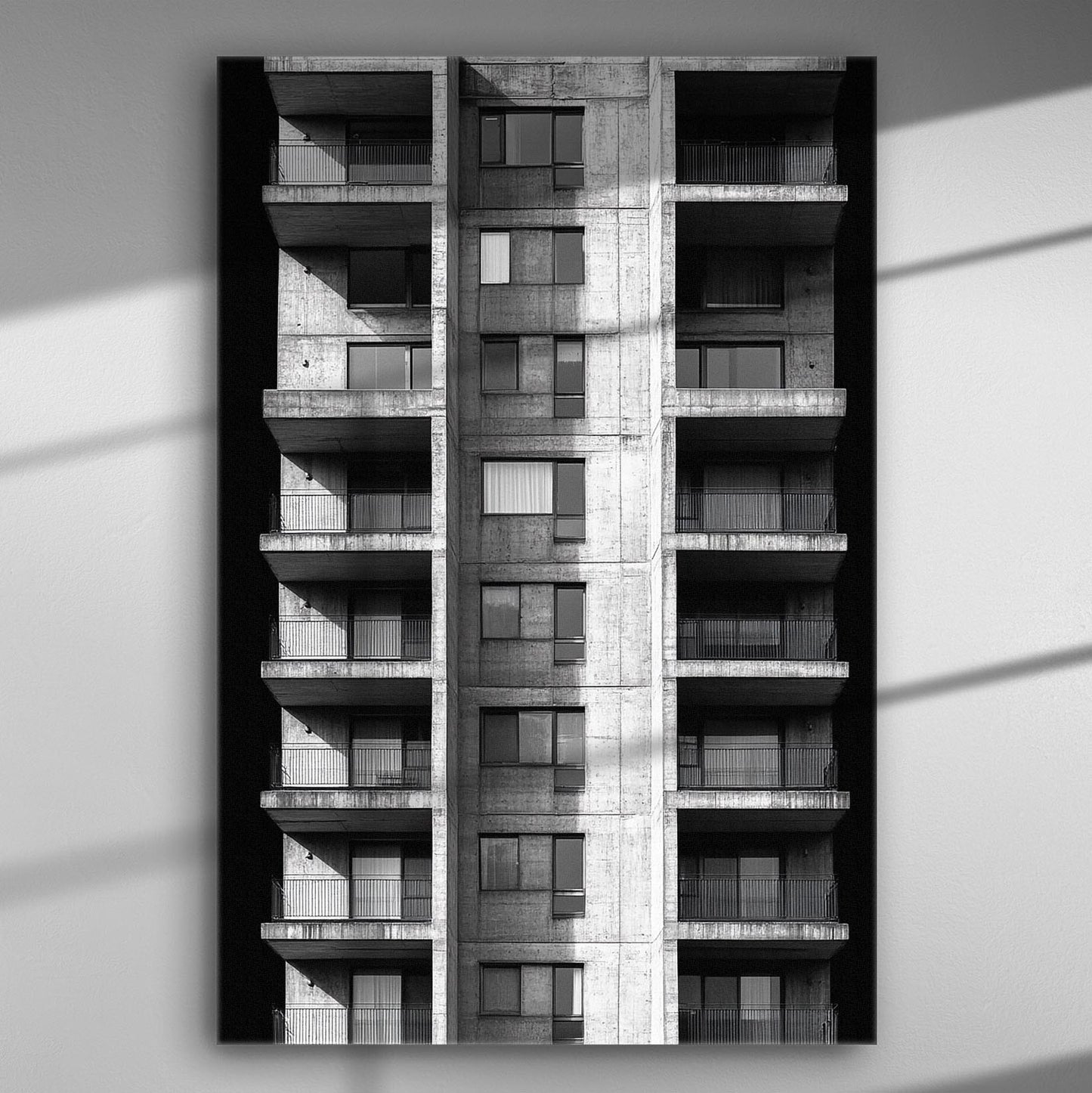 Black and white photograph of a modern residential building facade.