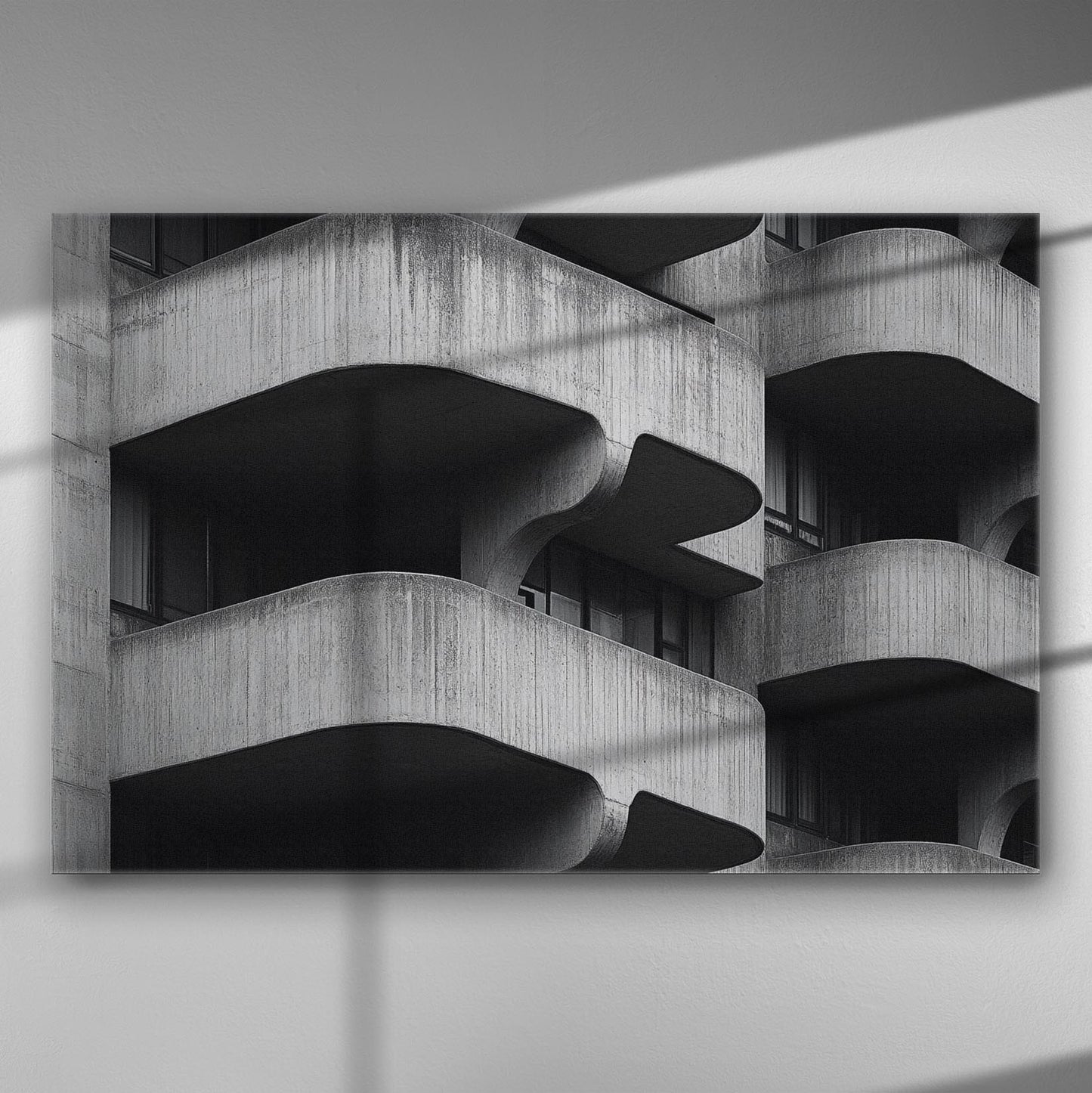 Black and white geometric architectural image with curved concrete balconies creating a bold pattern.