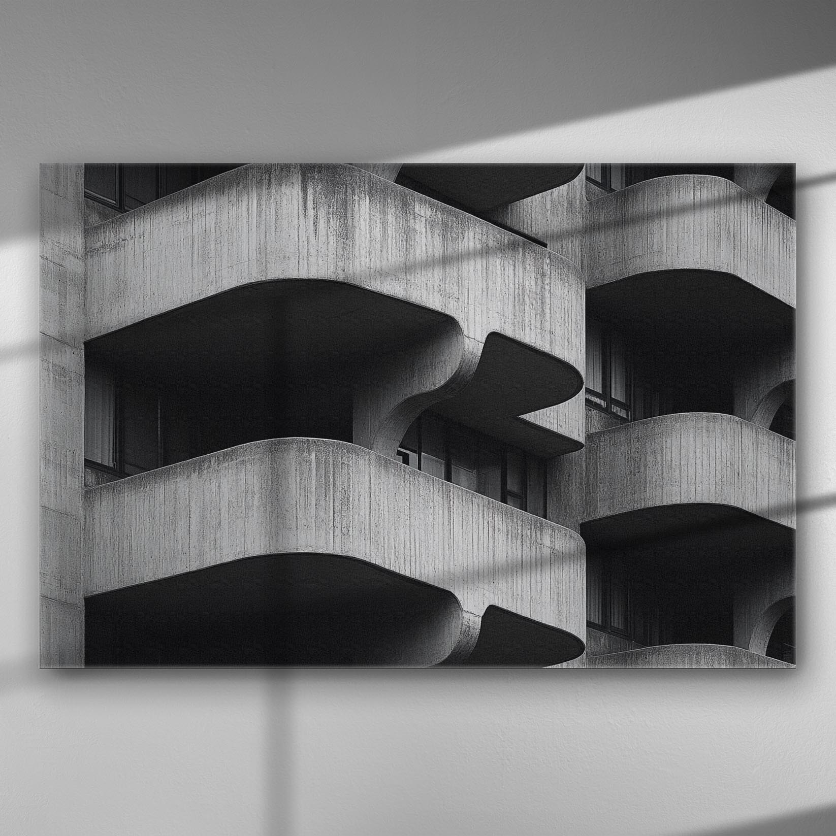 Black and white geometric architectural image with curved concrete balconies creating a bold pattern.
