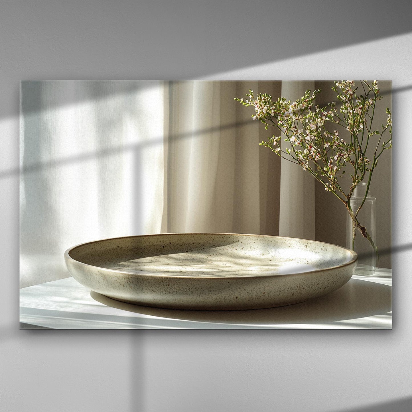 A serene canvas print depicting a floral branch next to a ceramic plate with soft lighting and curtains.