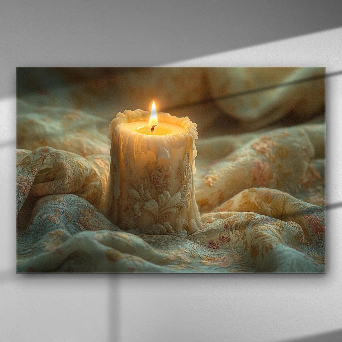 Candle with intricate wax drippings on a decorative fabric background.