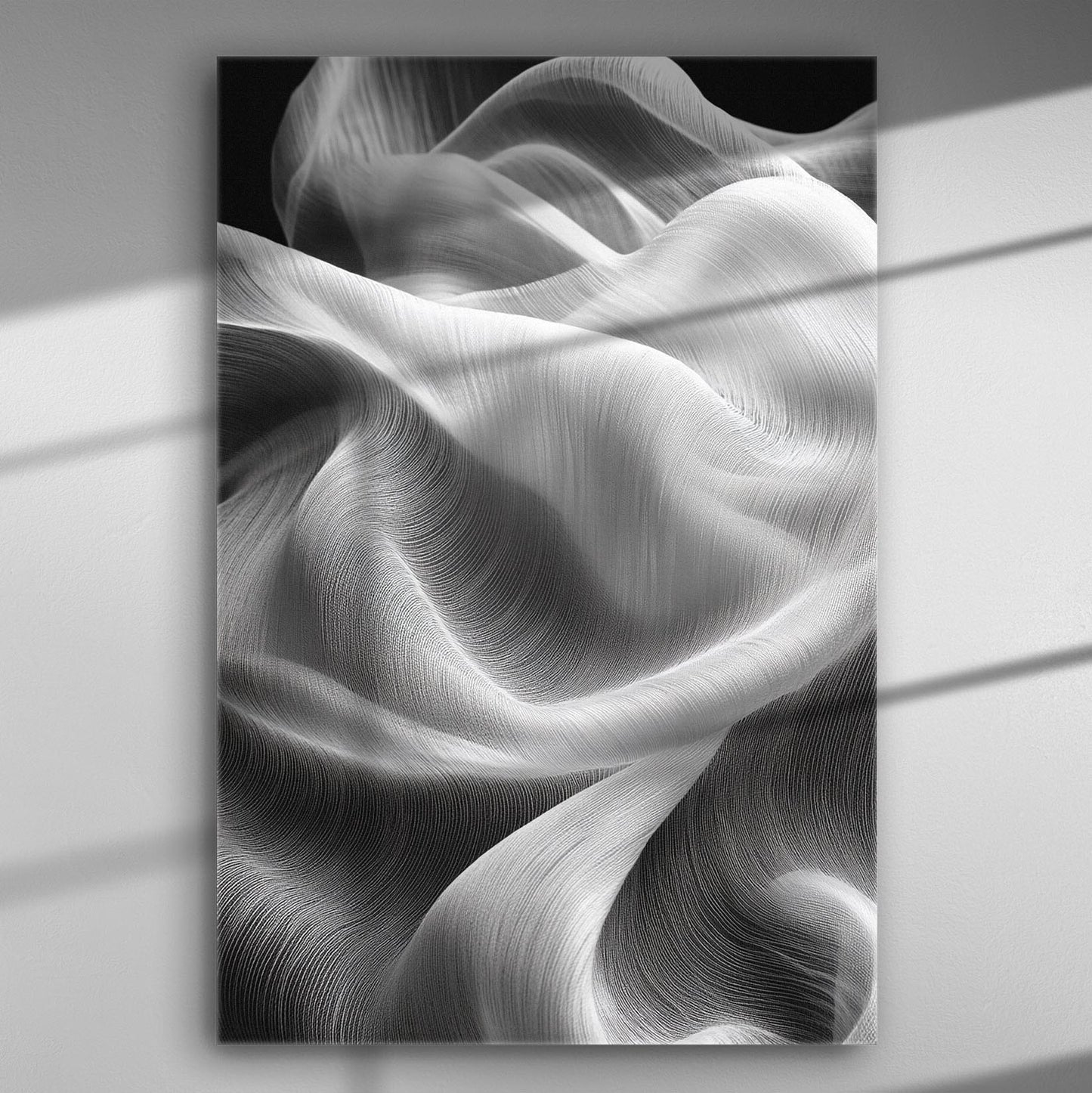 Flowing white fabric creating wave-like patterns in black and white canvas art.