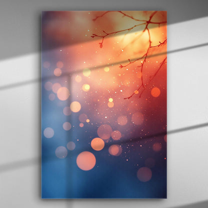 Abstract image with warm sunset colors, bokeh light spots, and tree branches.