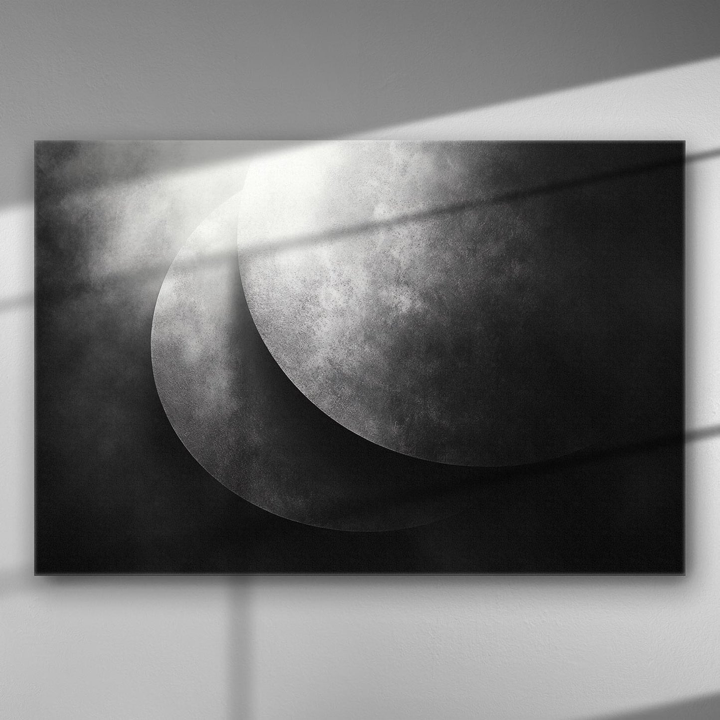 Abstract black and white artwork depicting moon shadows on canvas.