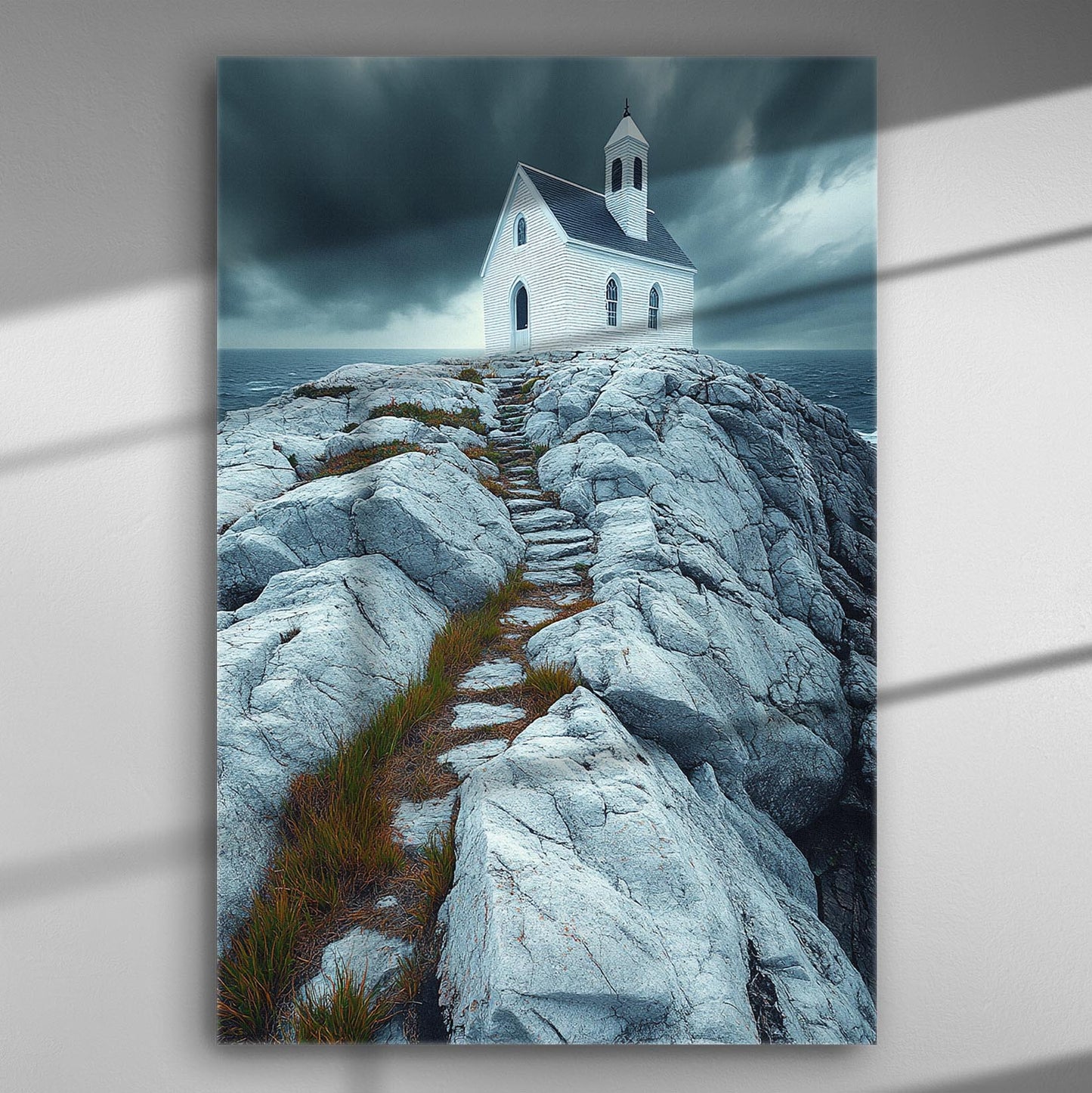 A canvas print of a white church on rocky cliffs with a dramatic sky.