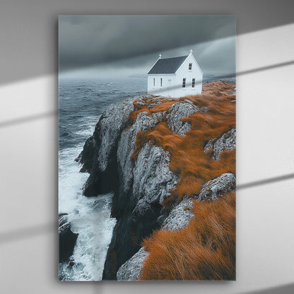 A white house on a rocky cliff with orange grass and a stormy sea backdrop, printed on canvas.