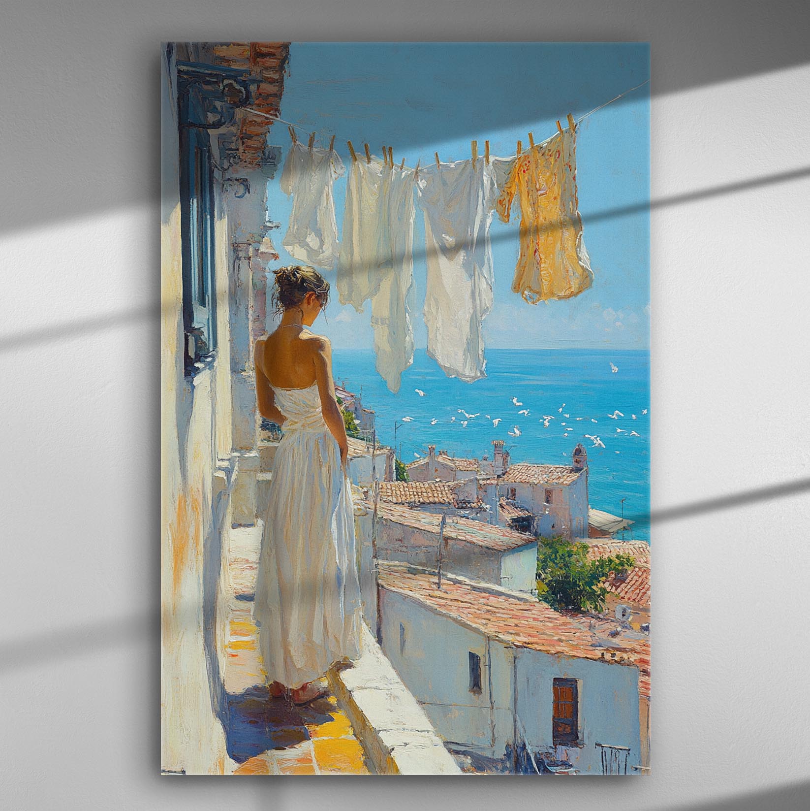A woman in white stands on a balcony overlooking the sea in a coastal village.