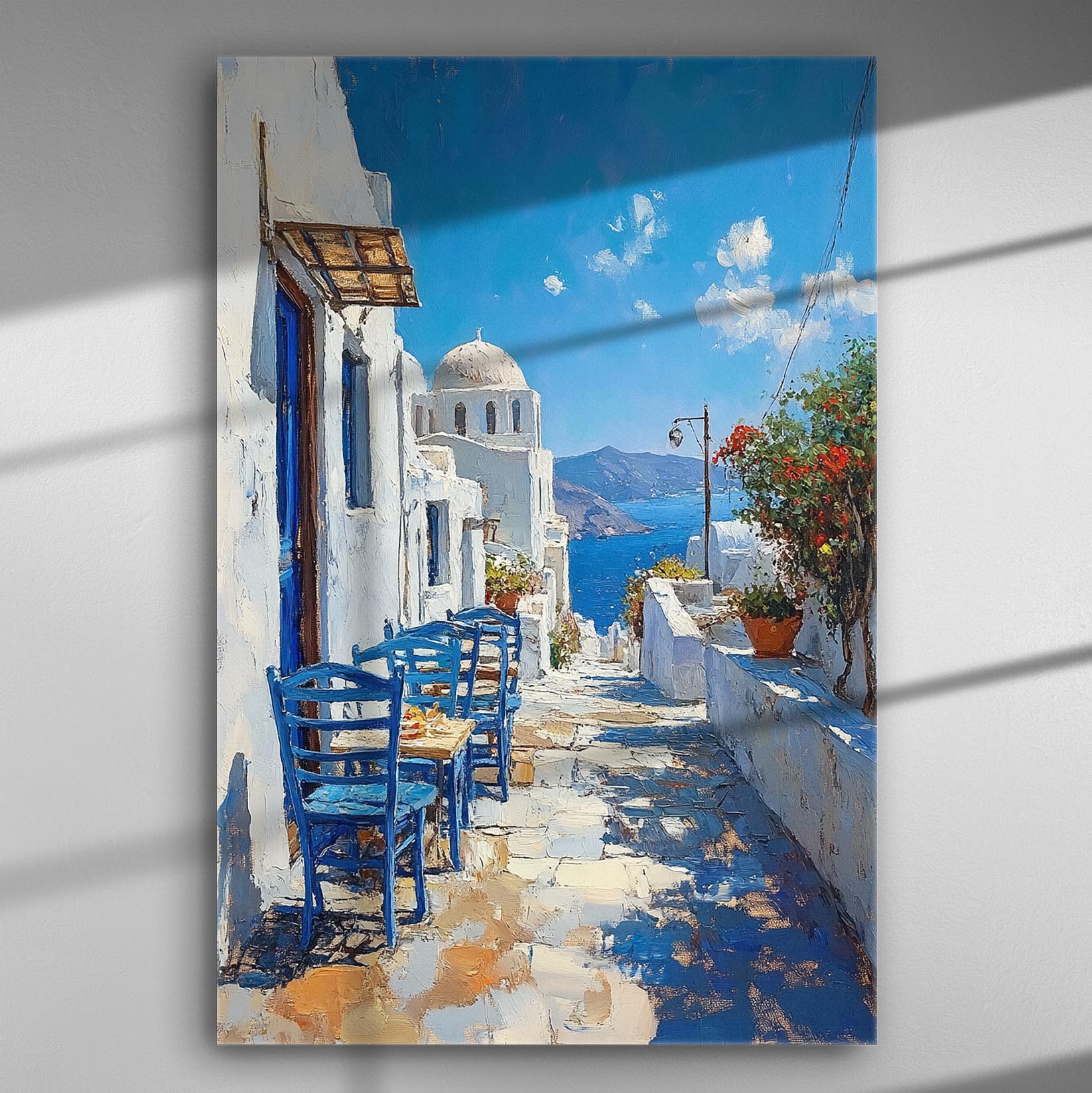 Painting of a Greek island scene with blue chairs, white buildings, and the sea in the background.